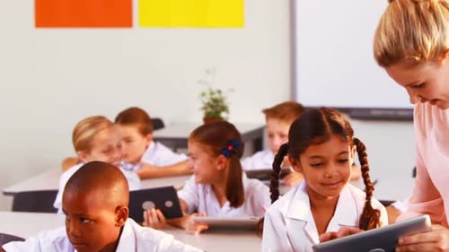Children Use Tablets in Bright Classroom Setting