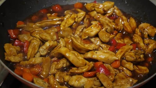 Chicken Cooking with Carrots and Red Bell Pepper