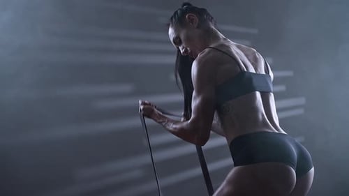 Muscular Woman Working Out with Resistance Bands