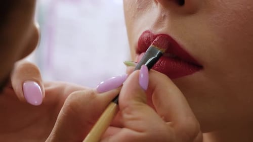 Applying Vivid Red Lipstick with a Brush