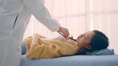 Close up hands of Asian physician doctor measure heart rate on patient.