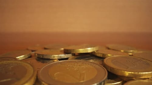 Pile of Euro Coins on a Wooden Table