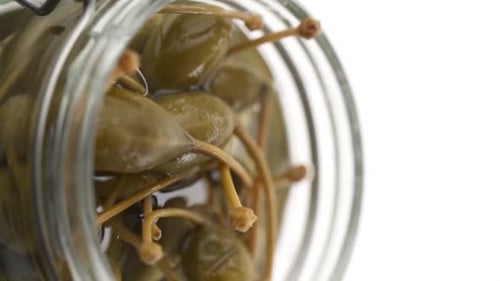 Vertical video: Canned olives in a jar