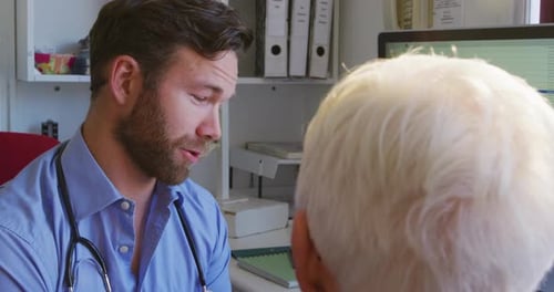 Friendly Doctor Discusses Health With Senior Woman