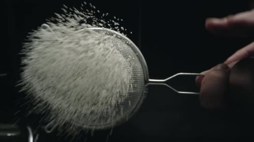 Sifting Flour with a Sieve in the Kitchen