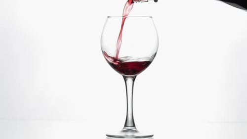Red Wine Being Poured into Glass