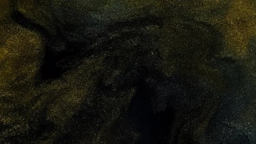 Belles particules dorées scintillantes avec reflet de lentille sur fond noir au Ralenti