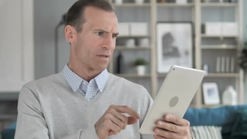Adult Man Frustrated and then Happy with Tablet
