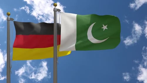 Germany and Pakistan National Flags Waving Against Blue Sky