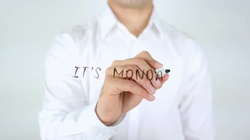 Man Writes It's Monday on Glass Surface