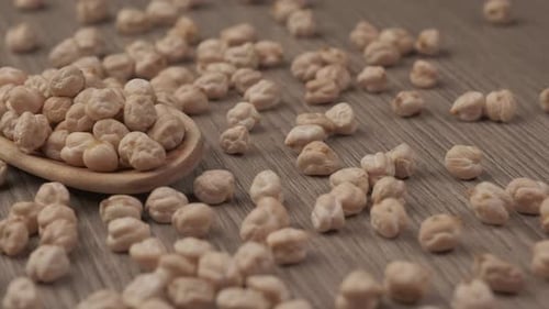 Dry chickpeas legumes on wooden spoon, vegan vegetarian protein source, healthy Mediterranean diet n