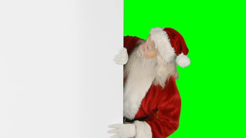 Papai Noel se escondendo atrás da tela verde