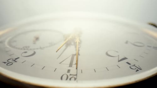 White Clock Face with Gold Hands Moving
