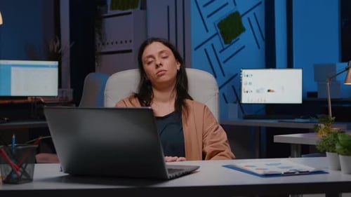 Tired Overworkes Businesswoman Sleeping in Startup Company Office on Desk Chair