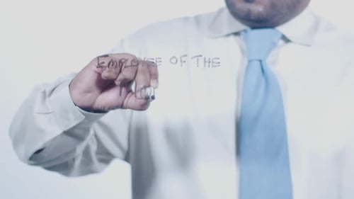 Person Writes 'Employee Of The Month' On Glass