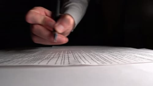 Hand Signing a Contract with a Pen