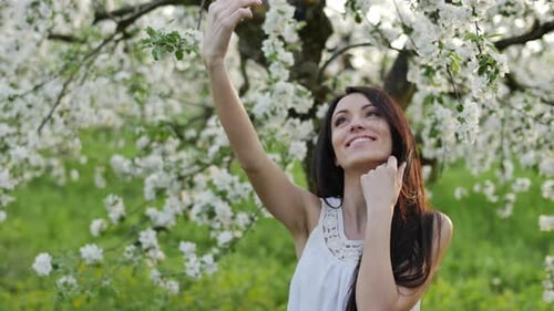 Woman Takes Selfie in Blossoming Spring Garden