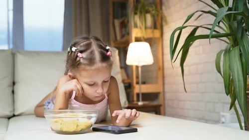 Child Using Tablet Device on Couch