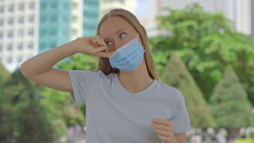 Young Woman on a Street Wearing Medical Face Mask in Order To Protect Herself Against Covid-19