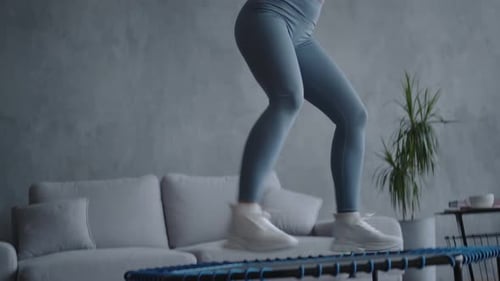 Active Woman Exercising on a Mini Trampoline