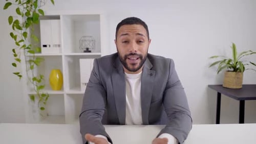 Webcam View of a Video Conference of a Latin Businessman Looking at a Serious Camera