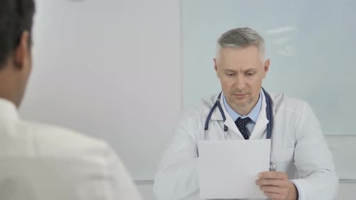 Doctor Speaking with Patient in His Office