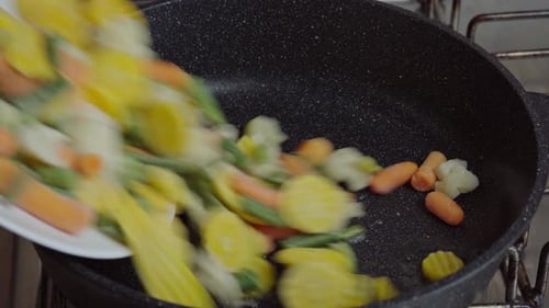 Close up view of steaming frying pan and mixed vegetables. Vegetarian