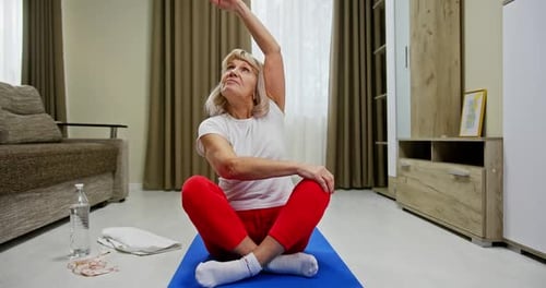 Woman Exercising on Yoga Mat in Living Room