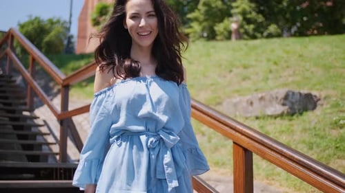 Beautiful Woman in Summer Fashion Dress Walking on Stairs in the Middle of City