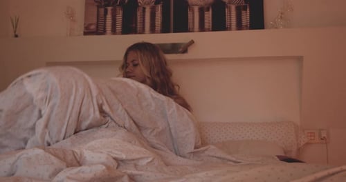 Beautiful Young Woman Getting Out Of Bed In Morning