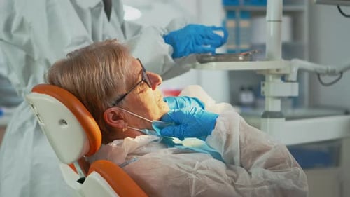 Senior Woman Undergoing Dental Exam at Clinic