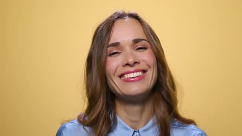 Positive Woman Laughing on Yellow Background. Happy Woman Smiling in Studio
