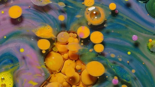 Ink Bubbles Mixed with Liquid Substance of Oil Milk Soap Bright Acrylic Paint on Colorful Surface
