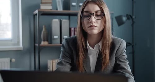 Serious Lady in Formal Clothing Working on Laptop at Office
