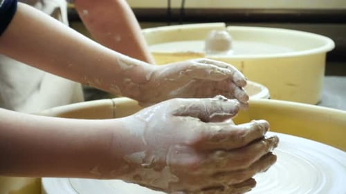 Potters Shaping Clay on a Pottery Wheel
