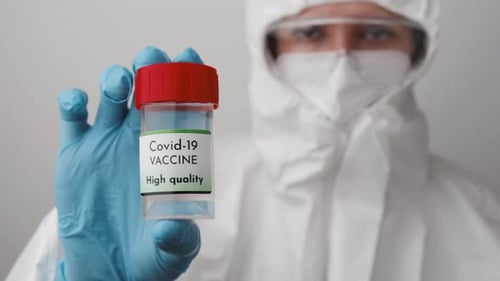 Doctor Holding Covid-19 Vaccine in Laboratory