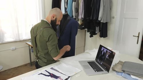 Tailor measuring a suit jacket