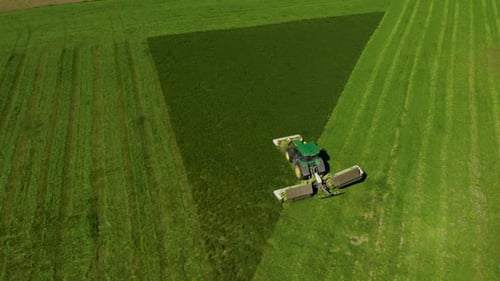 Green Tractor Harvesting Agricutlural Field of Wheat Aerial View