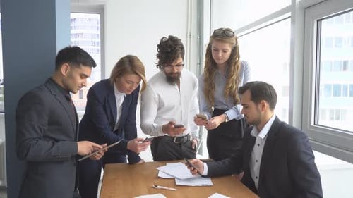Working Atmosphere in the Office. Group of Business People Discussing Business Issues