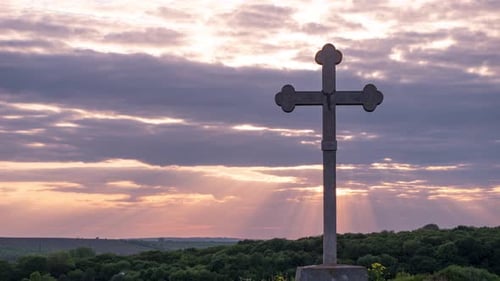 Stone Cross Silhouette at Sunrise or Sunset