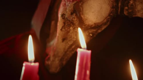 Scary Hooded Figure with Three Lit Pink Candles