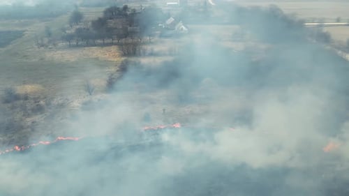 Aerial Flight Over the Fire in the Field