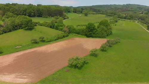Aerial View of Rolling Green Fields and Farmland