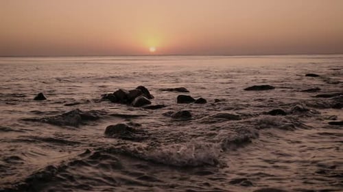 Golden Sunrise at Beach with Crashing Waves