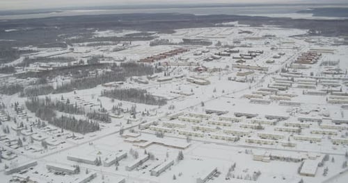 Steady helicopter aerial shot over green hills, cloudy day