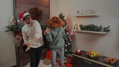 Happy couple in winter sweaters enjoy Christmas Eve and 2022 New Year