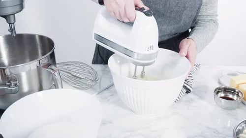 Step by step. Mixing ingredients in standing kitchen mixer to bake funfetti cake