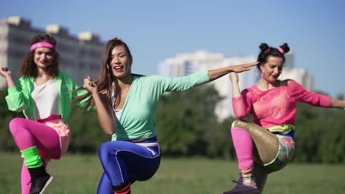 Women in 80s Outfits Doing Aerobics in Park