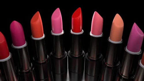 Lipsticks with the Red Palette Rotates on the Showcase in the Perfume Store