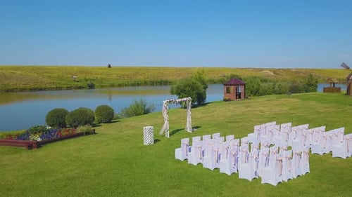 Wedding Venue with Arch on Meadow Near Pond Aerial View